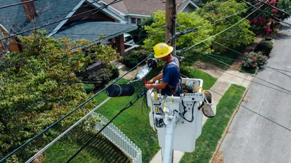 A worker fxing a utility pole