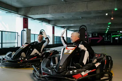 Two people high-fiving on a go-karts