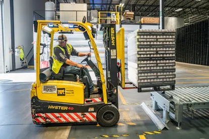 A worker driving forklift in a factory